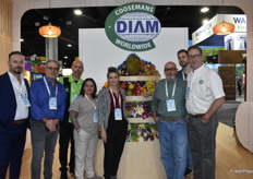 Team Coosemans Worldwide stands by a colorful display of exotic produce. 