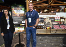 Rochelle Bohm and Loren Foss proudly stand by CMI Orchard's regenerative display. The company is building a center for soil health.