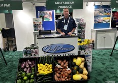 Craig proudly shows an array of produce at Gulfstream Produce’s booth.