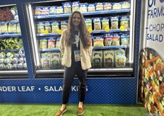 Braga Fresh’s Tatiana Briggs in front of some of the company’s bagged produce.