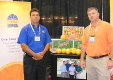 Robert Thomas and Matt Kastensmidt with their booth of IMG Citrus.