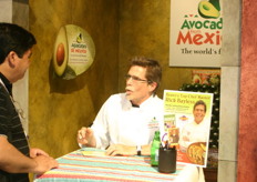 Top Chef Rick Bayless gives an autograph at the APEAM booth