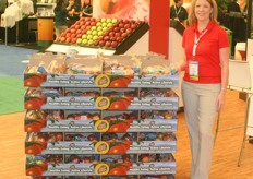 Maggie Peek of BC Tree Fruits stands next to a display retail pallet.