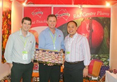 Ben Centra, Michael Silm and a customer in the booth of Montague Fresh promote the Autumn Honey Pluot. It is a cross between a plum and an apricot.