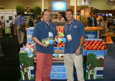 Brett Burdsal and Mark Hambelton stand next to Daisy Girl brand for organic apples.