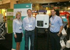 Connie Bordanaro, Andy Smith and Mark Sa of Purfresh. They stand next to a panel, which can be installed in a reefer container to eliminate ethylene and kill bacteria.