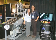 Nicole Sleiman and Terri Sleiman of Accu-label next to a new machine which prints and applies information on traceability.