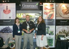 Kristen Francisco, Chris Martin and Julia Inestroza of Gourmet Trading Company promote their asparagus. Chris holds a bag with green, white and purple asparagus.