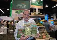 "Charlie Eagle from Southern Specialties holds French green beans and Brussels sprouts. The left French green beans have a special holiday label: "A delicious Holiday treat." www.southernspecialties.com"