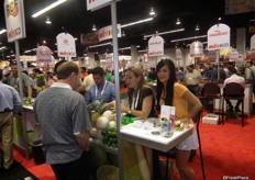 Mayra Romero and Jenny Li talking to a client at Fresco Produce’s stand, in Mexico’s hall.