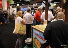 Visitors tasting samples at Itaueira’s stand, a firm from Brazil.