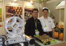 Tom McLaughlin and Jin Han showing the CR4 Fixed Multi Head labelling machine from Sinclair.