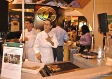 Chef at California Avocado booth samples fish in combination with avocado.