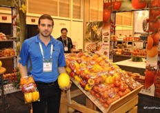 Mitchell Amicone of AMCO Produce holding a 6 pepper pack and a melon, which they started growin in their greenhouse as well.