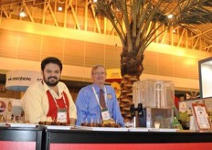 Juan Guzman and Dave Nelson from Bard Valley Medjool Date growers, with at the back a date palm tree.